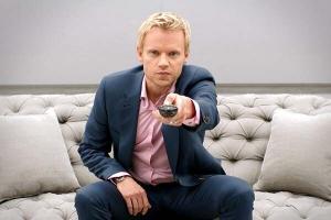 Man holding a television remote control